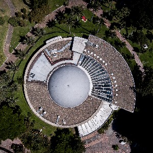 Aerial photography of the Bogotá District Planetarium. Its snail-like shape is surrounded by a park